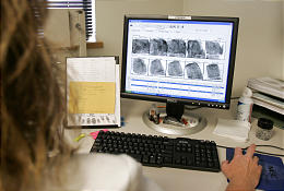 Valorie Webster does fingerprint checks at the Bureau of Criminal Identification in Kearns, Utah. (Douglas C. Pizac, Associated Press)