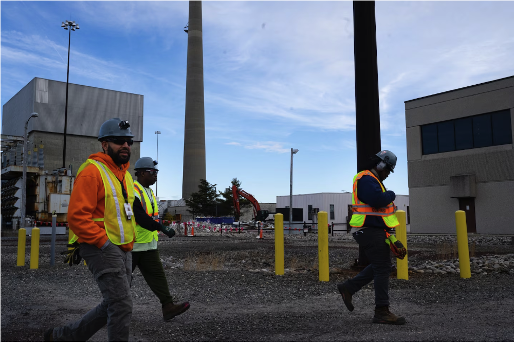 Workers walk past the site of a building demolition at Oyster Creek Nuclear Generating Station in New Jersey. Regulators have documented at least nine violations of federal rules at the plant under Holtec’s ownership. (Sarah L. Voisin/The Washington Post)